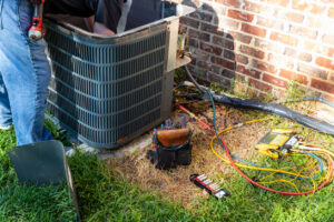 HVAC technician checking out an AC condenser unit