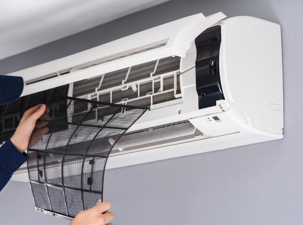 AC technician replacing mini-split filter