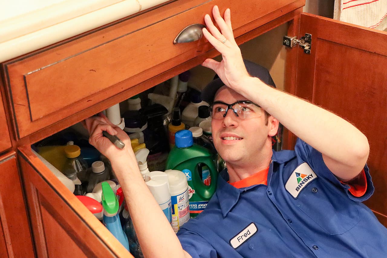 Plumber repairing a kitchen sink